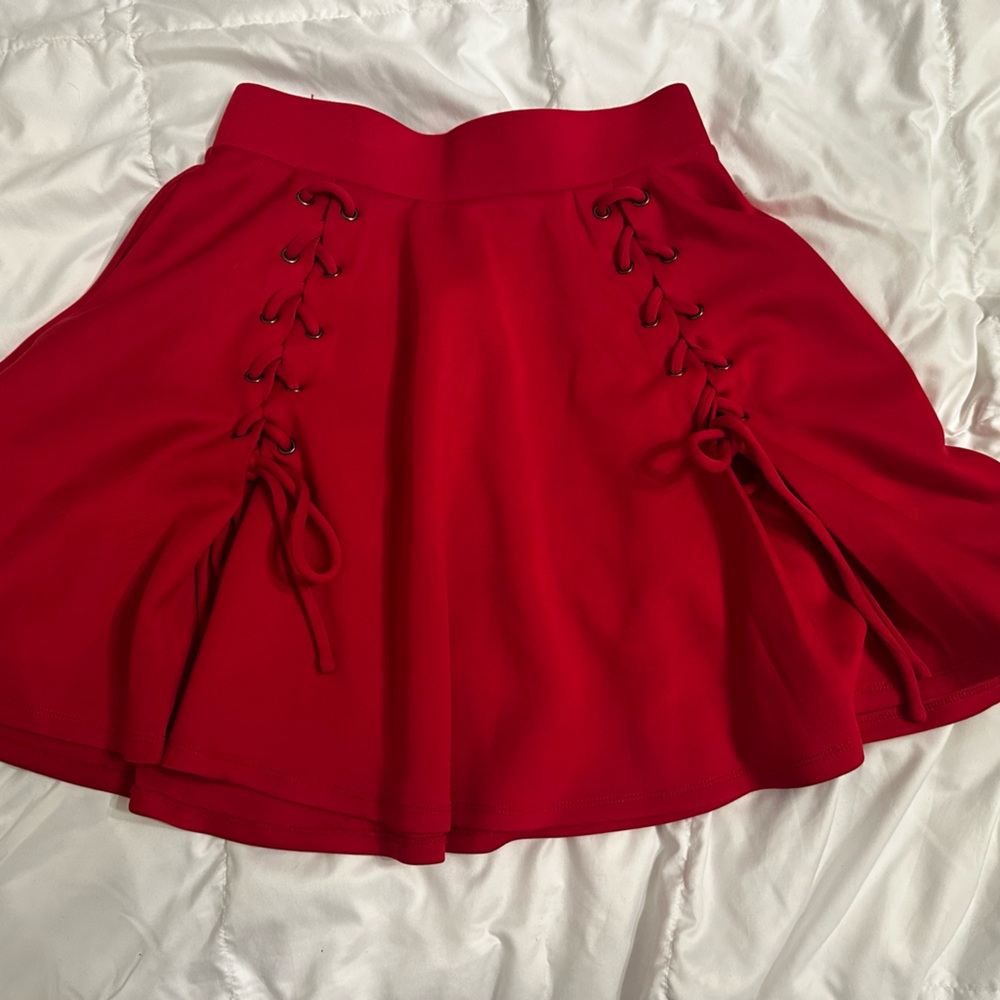 Hot topic mini skirt with tie and grommet details. Pockets. Red